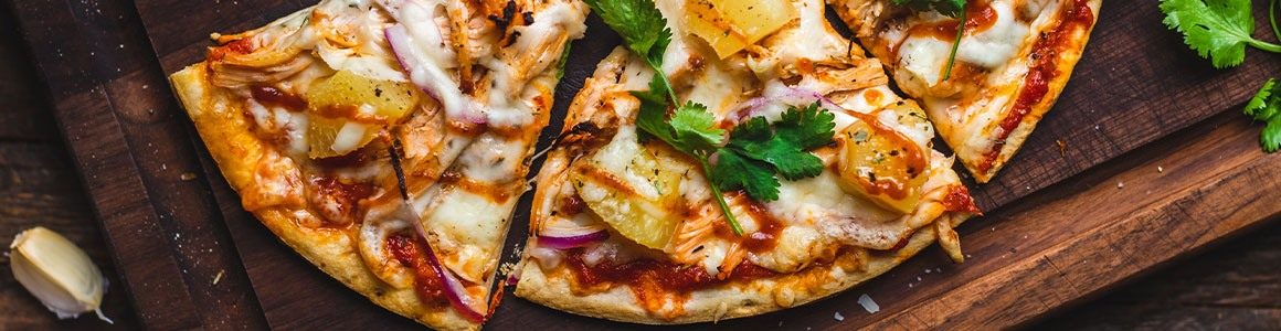 Pineapple Pizza garnished with basil.