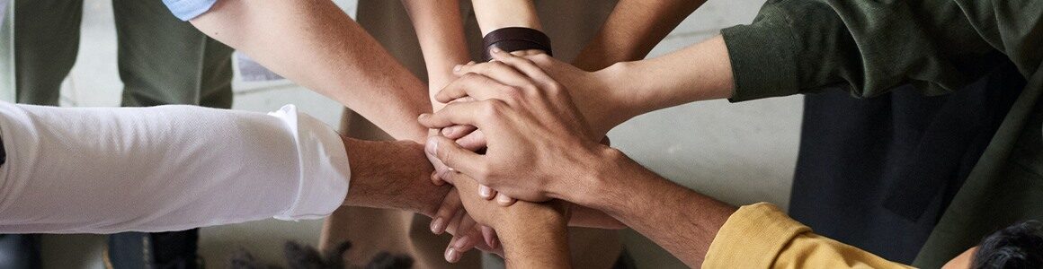 Diversity of people put their hands in together.