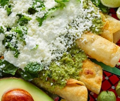 Mexican cheese on enchiladas with salsa and guacamole.