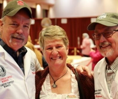 Wisconsin Cheese makers Steve Stettler, Esther Zgraggen, and Bruce Workman at the 2024 World Championship Cheese Contest in Madison, WI.
