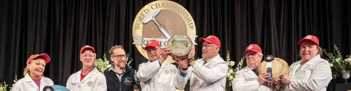 World Champion Cheesemaker, Michael Spycher, holds up the 2024 World Champion Cheese, Hornbacher, at the World Championship Cheese Contest in Madison, Wisconsin.