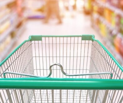 Food and beverage items lined up in a grocery store aisle.