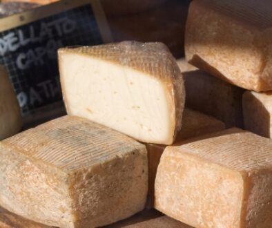 Parmesan blocks, gorgonzola, and cheddar wheels.