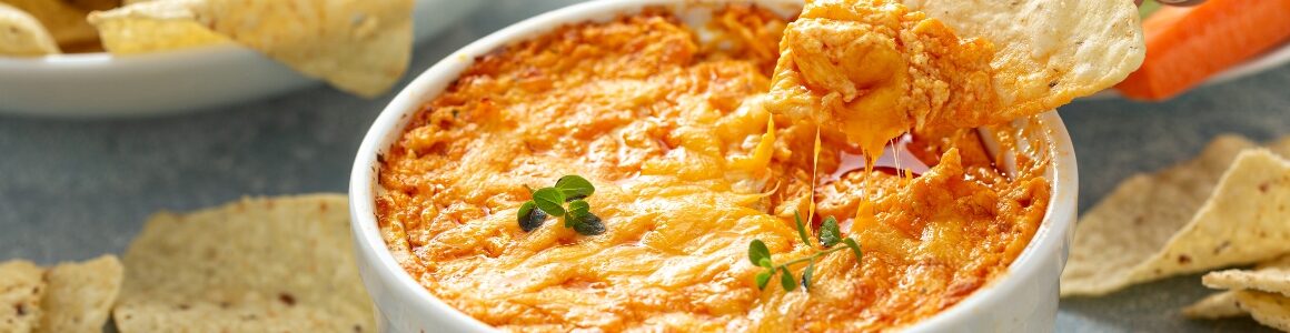 Tortilla chips in a buffalo chicken dip