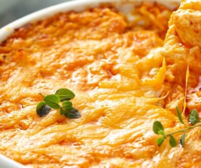 Tortilla chips in a buffalo chicken dip