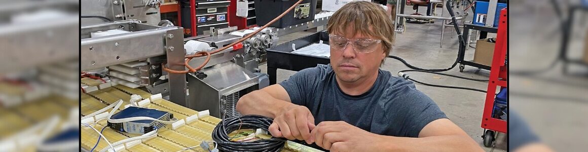 HART Design & Manufacturing works with wiring on industrial machinery.