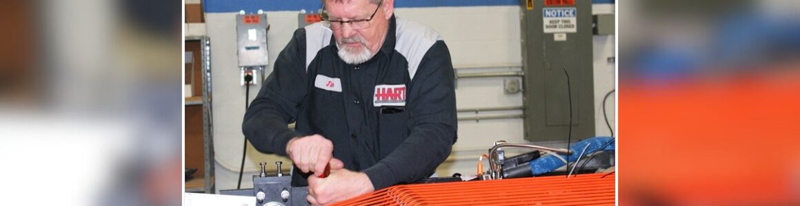 A HART technician performs precision work on equipment inside the manufacturing facility.
