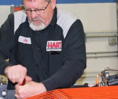 A HART technician performs precision work on equipment inside the manufacturing facility.