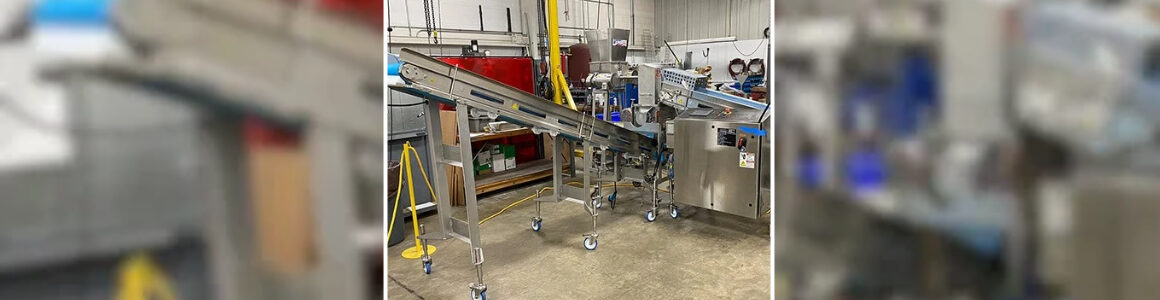 HART Design & Manufacturing cheese crumble line equipment with stainless steel conveyors in a manufacturing facility.